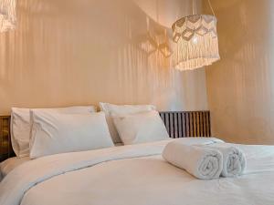 a bedroom with two beds with white sheets and pillows at Olivia in Vung Tau