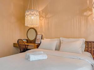 a bedroom with a bed with a towel on it at Olivia in Vung Tau