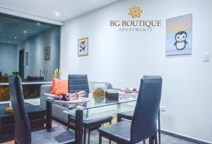 a dining room with a glass table and chairs at BG Boutique Apartments in Quito