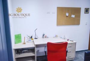 an office with a desk and a red chair at BG Boutique Apartments in Quito