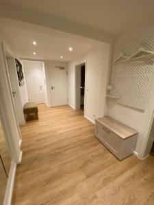 an empty living room with wooden floors and white walls at Ferienwohnung Luxusblick in Bad Harzburg