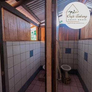a bathroom with a toilet and a sink at Cafe Sabang Guest House in Sabang