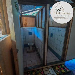 a small bathroom with a toilet in it at Cafe Sabang Guest House in Sabang