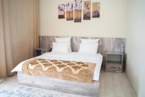a bedroom with a large bed and a tv at Aktau Airport Hotel in Aktau