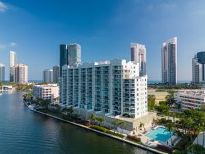 a large building next to a body of water at Waterfront luxury new apartment in Miami Beach