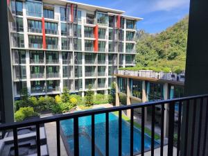 - Balcón con vistas a un edificio con piscina en A2 at Forest Khaoyai, en Ban Huai Sok Noi