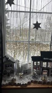 una ventana con casas de jengibre de Navidad y estrellas en ella en Pension U Václava, en Janov