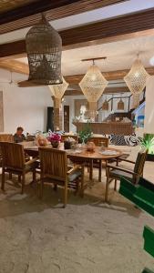 a dining room with a wooden table and chairs at Iru Maldives in Thulusdhoo