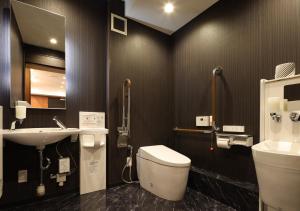 a bathroom with a toilet and a sink at APA Hotel Koriyama Ekimae in Koriyama +59 photos