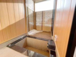 a small bathroom with a mirror and a window at Niseko White Villas1 in Niseko +33 photos