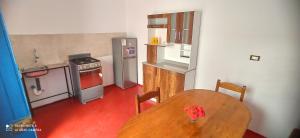 a kitchen with a wooden table and a kitchen with a stove at APARMENT SAMANA HOUSE AREQUIPA in Arequipa