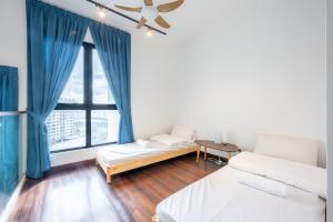 a room with two beds and a window with blue curtains at HighPark Suites by Airhost in Petaling Jaya +37 photos