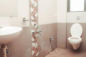 a bathroom with a toilet and a sink at Anant Resort Nagaon Beach Walking Distance 2min Alibaug in Alibaug