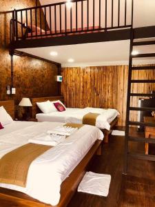 a bedroom with three beds and a loft bed at กอบสุข รีสอร์ท2 k13 in Ban Ton Liang