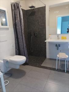 a bathroom with a shower and a toilet and a sink at dimora Spine Bianche in Matera