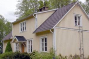 a large white house with a black roof at Solvikens Pensionat in Ingelstad +17 photos