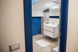 a bathroom with a sink and a mirror at Karma Resort in Venetico