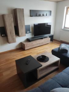 a living room with a large flat screen tv at Ferienwohnung Moselzeit in Alken