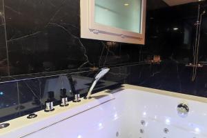 a bathroom with a sink with a faucet at Studio paisible et balnéo in Vezin-le-Coquet