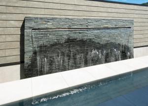 a brick wall next to a swimming pool at villa-rizo 山田 in Takayama