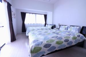 a bedroom with a bed and a large window at GRAND MER Agarie / Vacation STAY 21938 in Nago