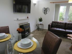 a living room with a table and a couch at Remarkable and perfect 3 Bed House in Nottingham in Nottingham
