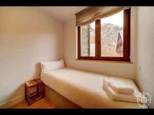 A bed or beds in a room at SANTA MARGALIDA de Alma de Nieve