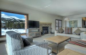 sala de estar con chimenea y TV en Mountain Elegant, en Breckenridge