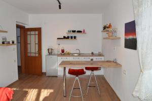 a kitchen with a counter and two bar stools at RH Tirana Center in Tirana