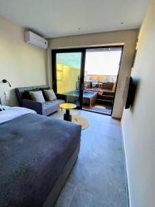 1 dormitorio con 1 cama y sala de estar en Skiathos Gea Villas, en Achladies