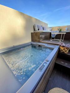 a hot tub on the deck of a house at Skiathos Gea Villas in Achladies