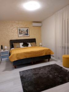a bedroom with a bed with a cat laying on it at Apartman River Una in Bihać