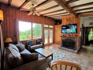 a living room with a couch and a fireplace at Its Owl Good in Luray