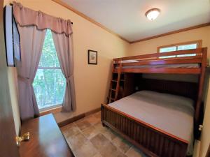a bedroom with two bunk beds and a window at Its Owl Good in Luray