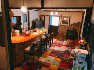 a kitchen with a bar and chairs in a room at 古民家 羅美 Japanese Old Style house La vie in Ayabe
