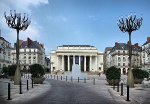 a large building with a fountain in front of it at A L'OMBRE DES 2 TILLEULS maison d'hôtes adults only in Sainte-Pazanne +16 photos