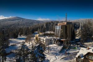 a resort in the snow with a mountain in the background at Interferie Sport Hotel Bornit in Szklarska Poręba