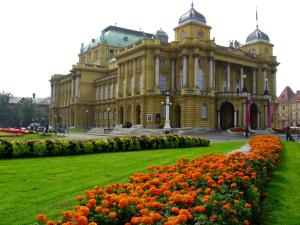 a large building with a bunch of flowers in front at Bianka Apartment in Zagreb