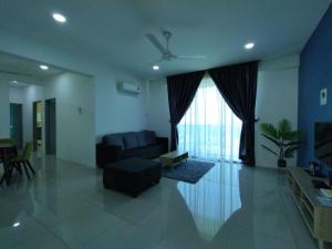 a living room with a couch and a window at 191 Cozy Casa Kayangan 3BR 6pax by Grab A Stay in Ipoh