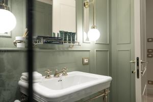 a bathroom with a white sink and a mirror at Hotel La Gemma in Florence