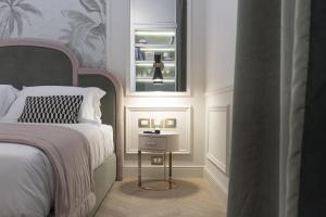 a bedroom with a bed and a nightstand and a window at Hotel La Gemma in Florence
