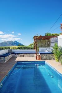 a swimming pool in the backyard of a house at Hout & About Guest House in Hout Bay