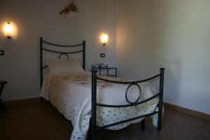 a bedroom with a bed with a white comforter at Il Poggiolo in Montieri