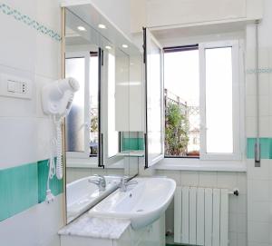 a bathroom with a sink and a mirror at Holiday rental St Peter's area in Rome
