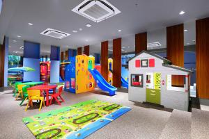 a play room with a slide and a playground at Atria Hotel Gading Serpong in Serpong