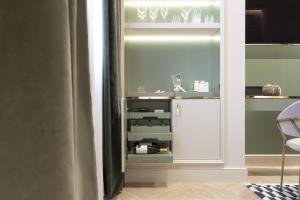 a glass door refrigerator in a room at Hotel La Gemma in Florence