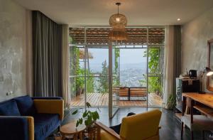 a living room with a couch and a large window at Eagle View Lodge - Kigali in Kigali