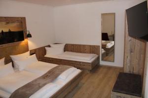 a hotel room with two beds and a mirror at Bayerische Gastwirtschaft Dimpfl-Stadl in Lam