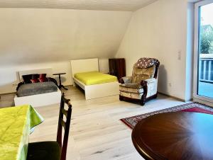 a living room with a bed and a table at Ferienwohnung mit Balkon - 3 Zimmer in Wedemark
