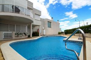 a swimming pool in front of a house at 4 bedrooms house at Sitges 100 m away from the beach with sea view shared pool and furnished terrace in Sitges